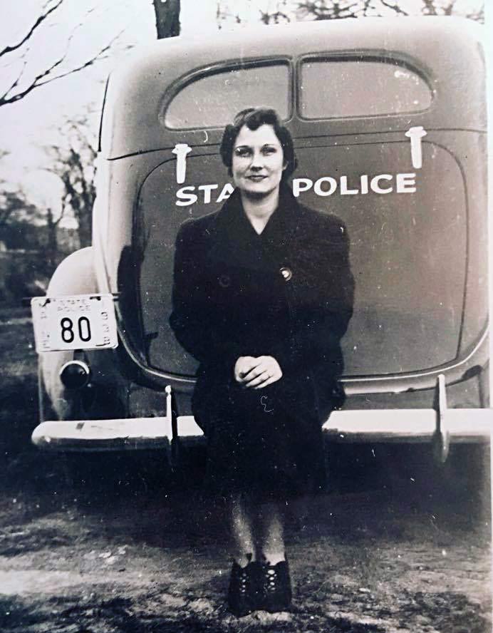 ladie sitting on back of Maine police car 1938